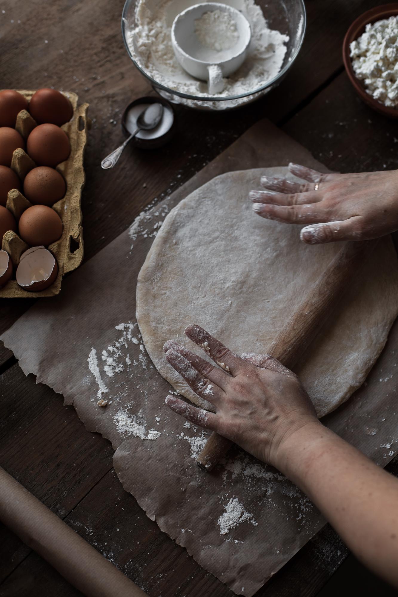 Close-up of hands kneading dough in warm kitchen light
